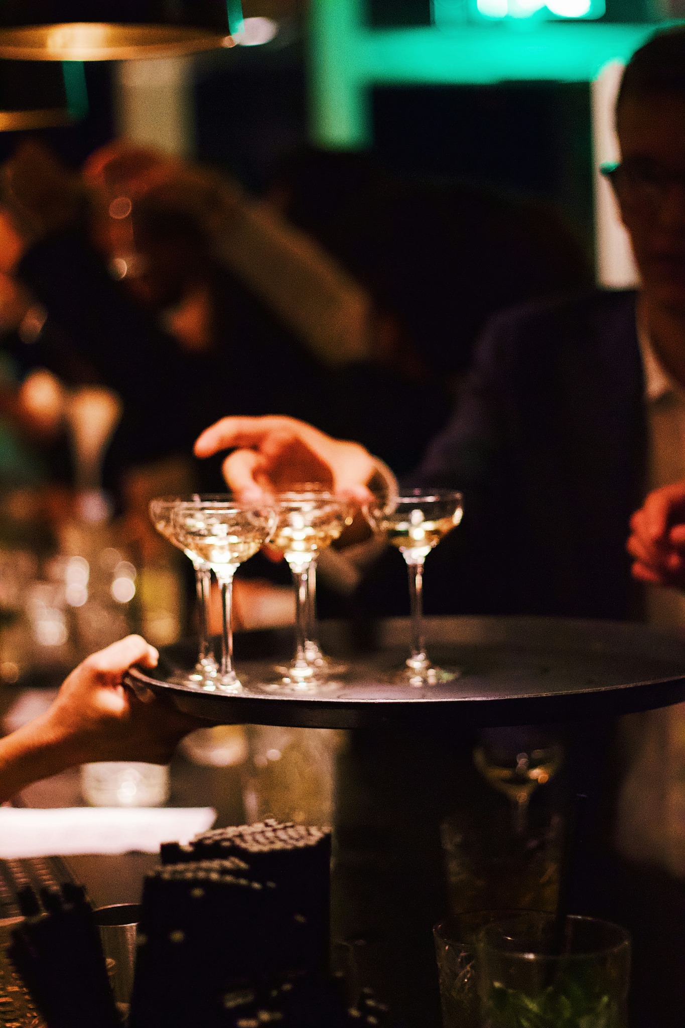Server carrying cocktails during service
