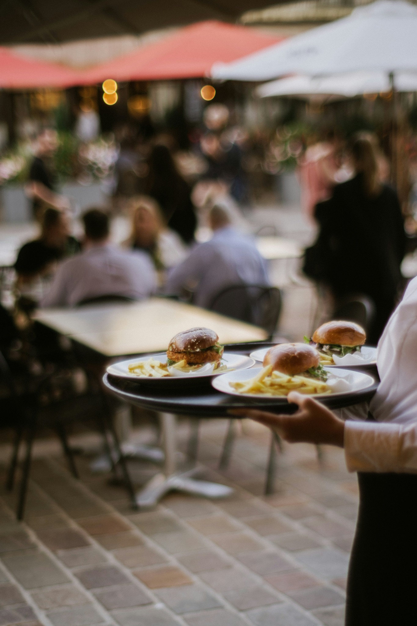 Hospitality server carrying plated food